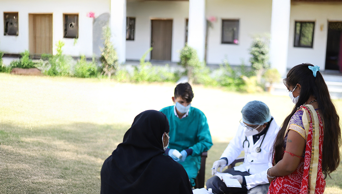 closeup-shot-doctors-patients-with-masks-sitting-outside-checking-list 1